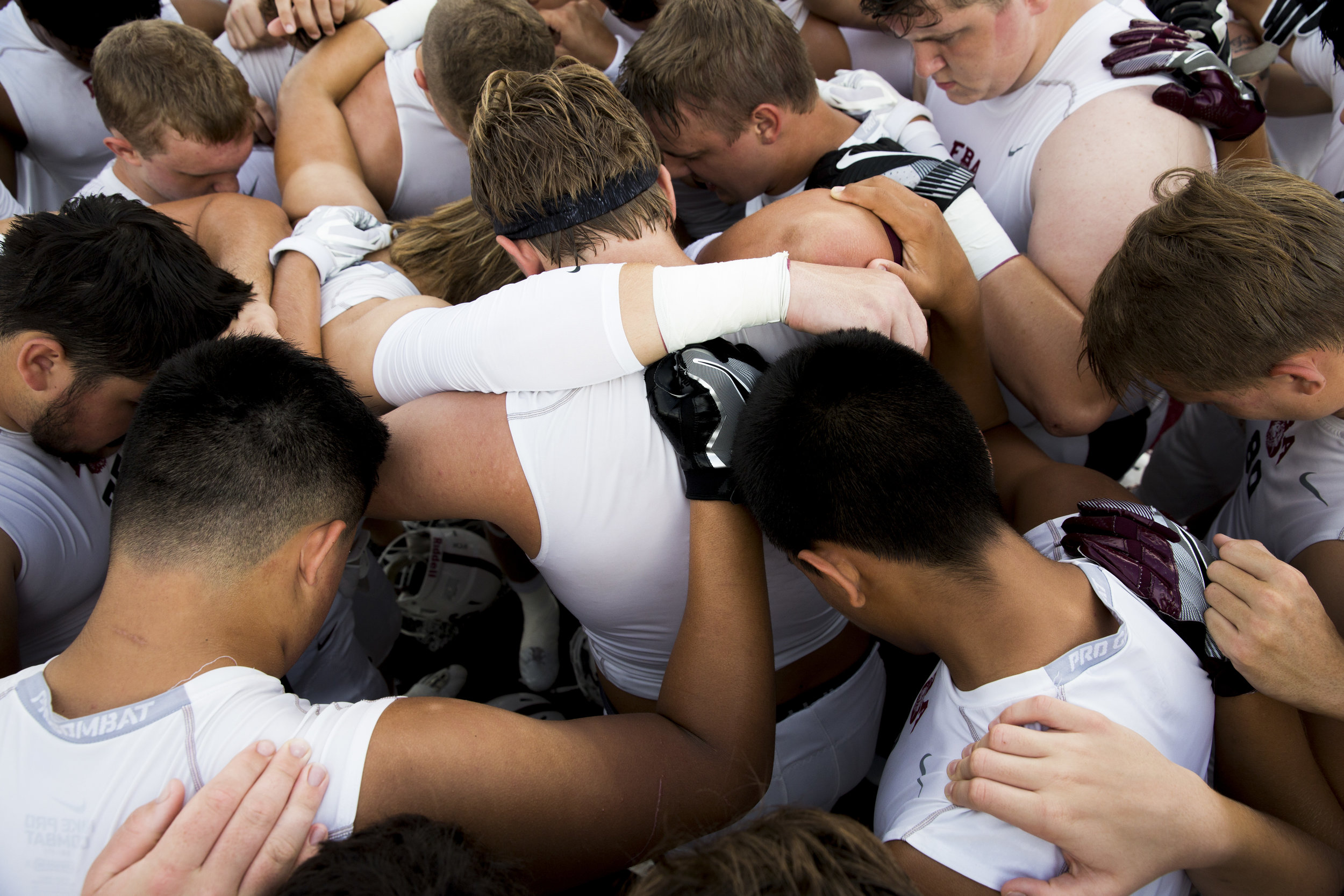  First Baptist Academy players huddle for prayer prior to their game September 1, 2017 in Naples, Fla.  