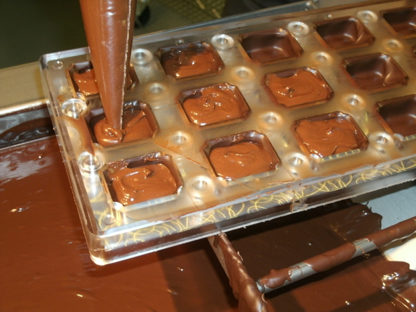 Piping in the ganache filling for some delicious chocolate truffles!