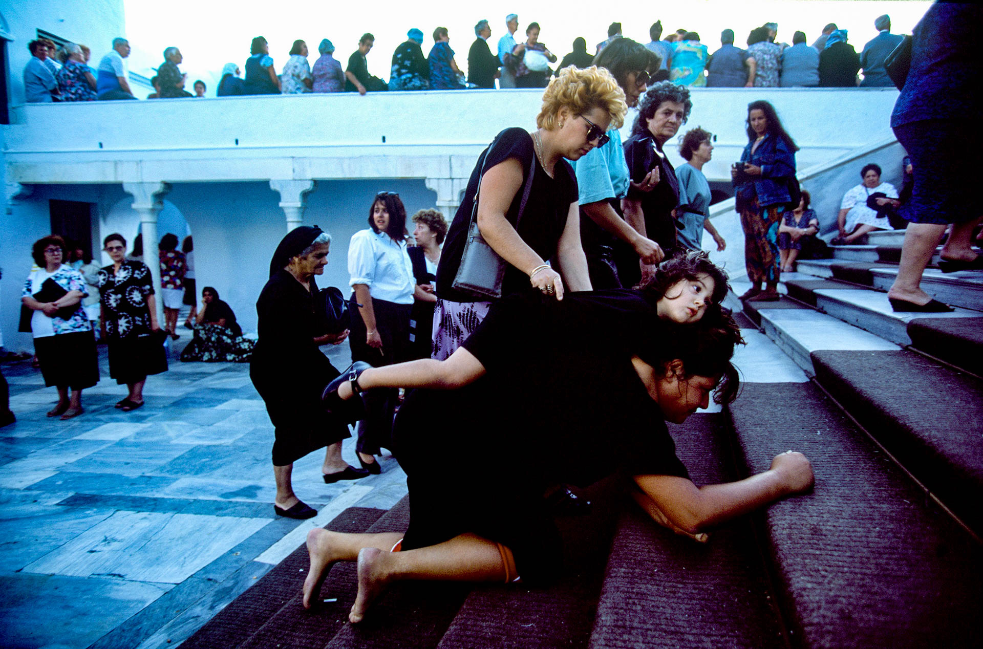  The miracle around the world: a woman carrying her paralyzed daughter on her back. 