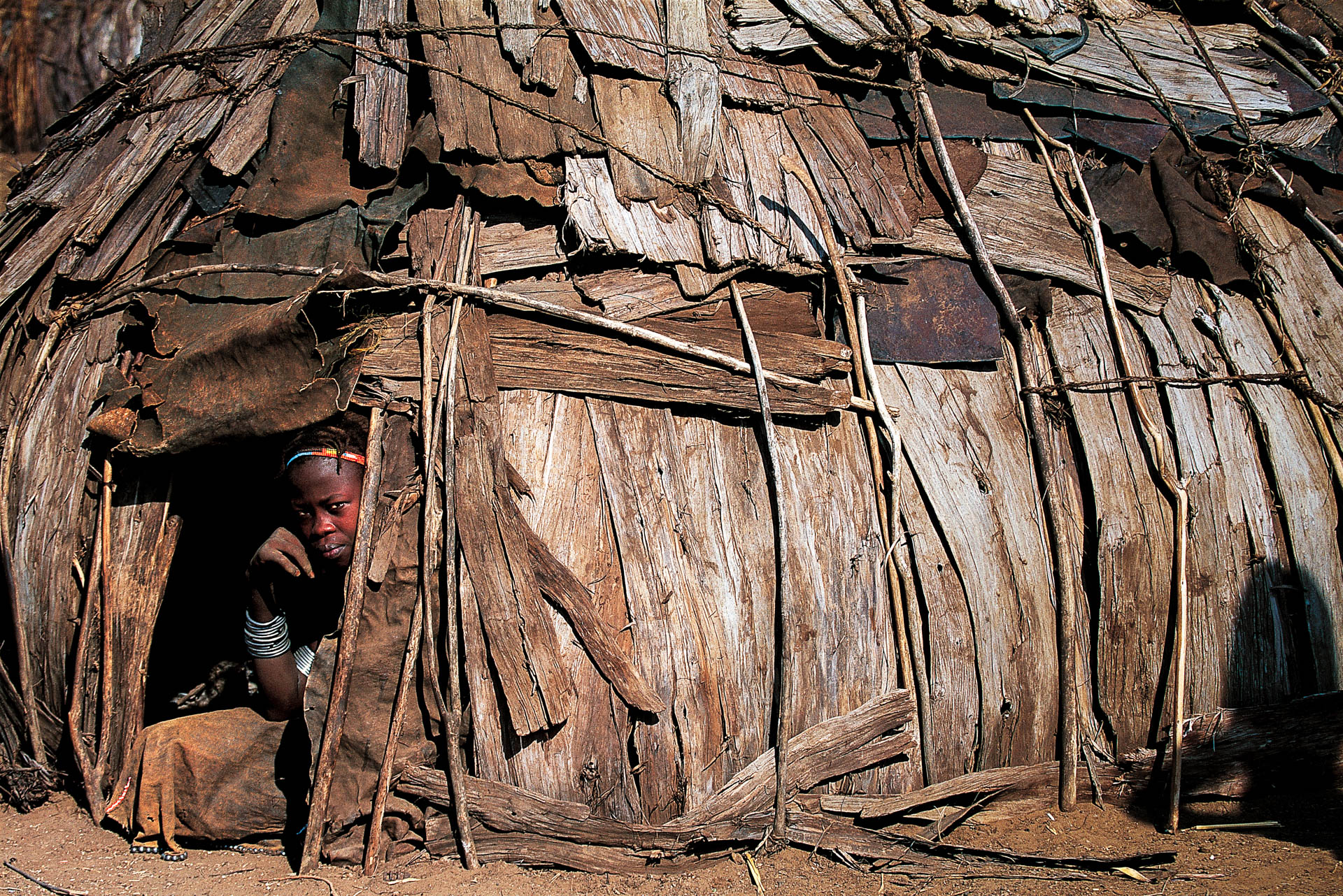 At Rate the children find shade in the huts.