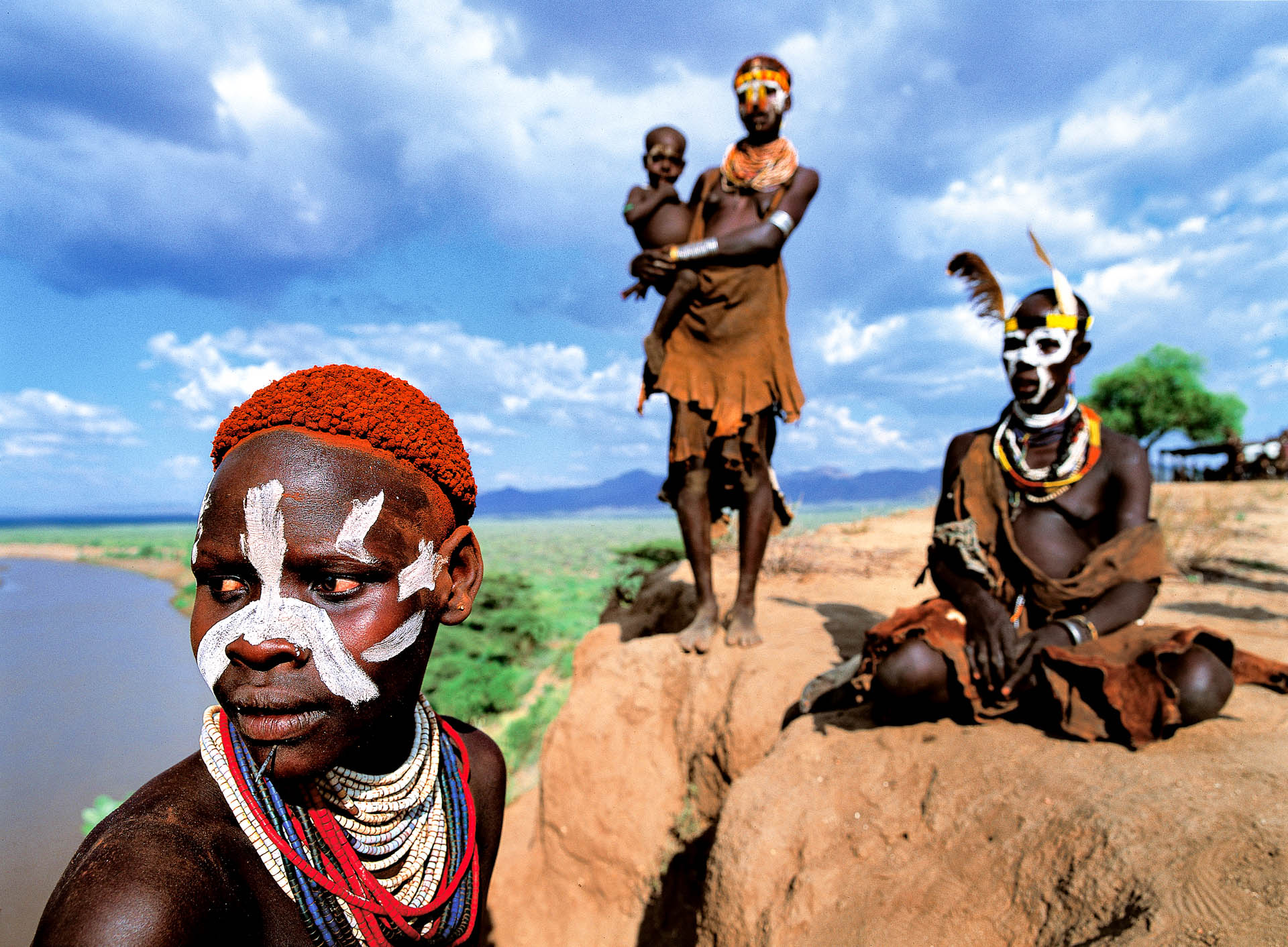 A group of women standing on the promontory close to their village.