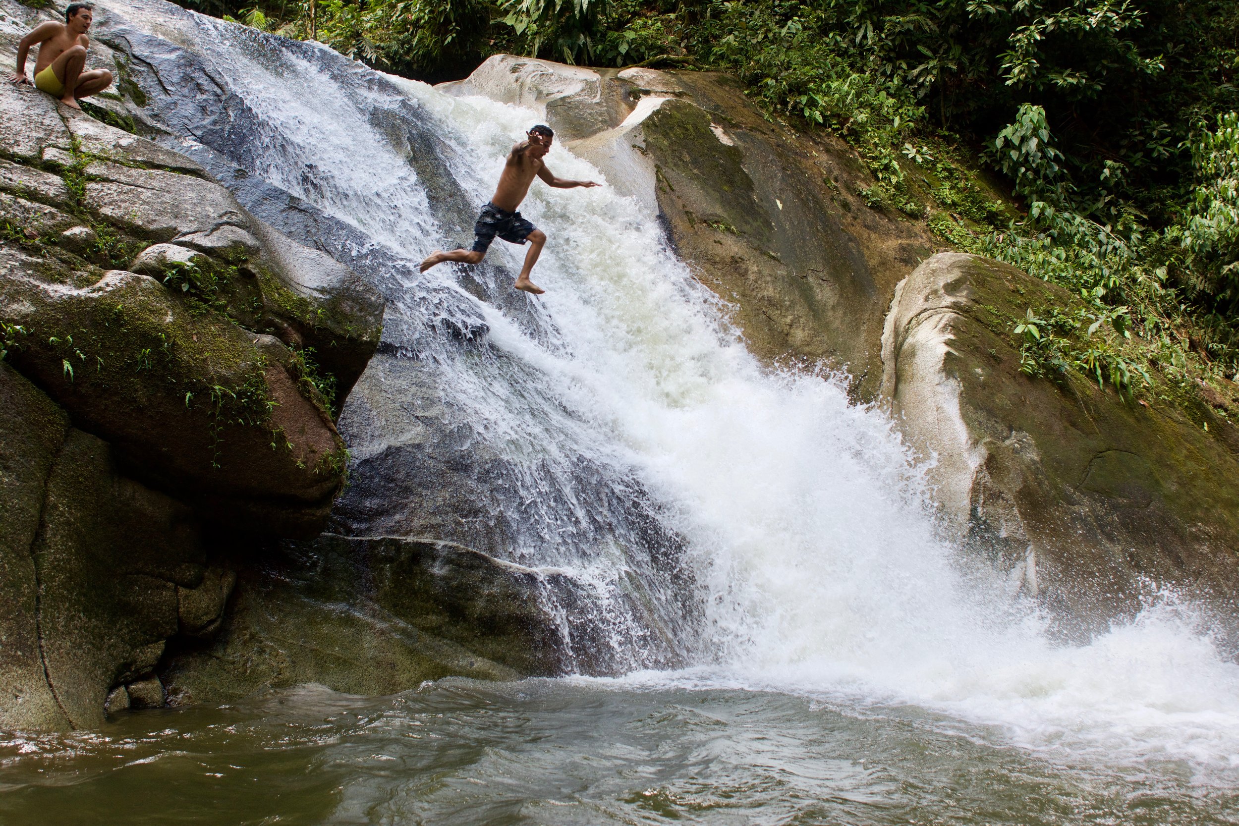 Daniel jumping off a waterfall
