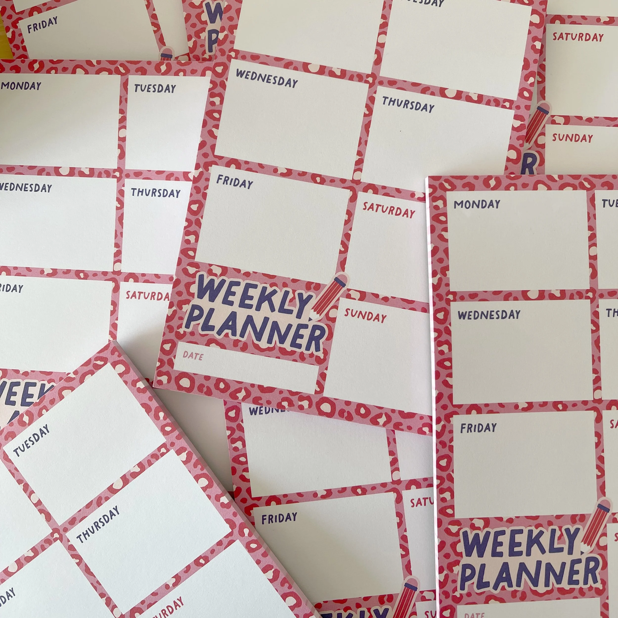 a pile of a5 weekly planner pads