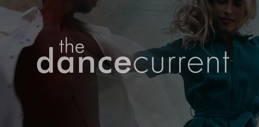 Two people dancing outdoors with the text 'the dance current' overlaid