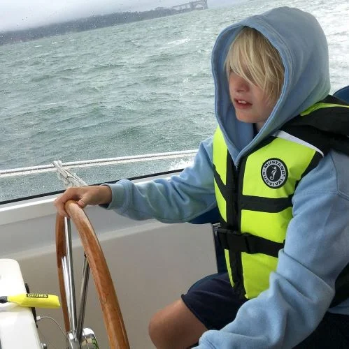 Finn driving a motorboat_cropped.jpeg