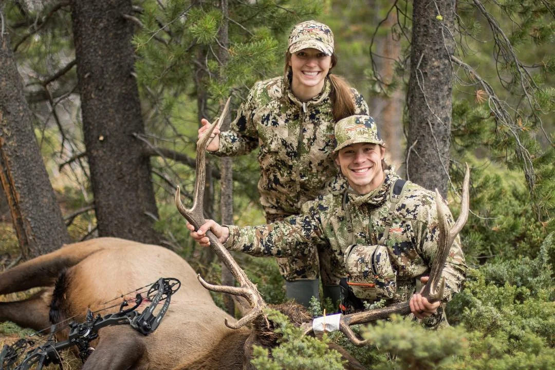 Cara Harper with her husband Grant and his 2018 DIY archery elk on public land. In the episode, Cara explains how she called in this elk so Grant could get a shot.