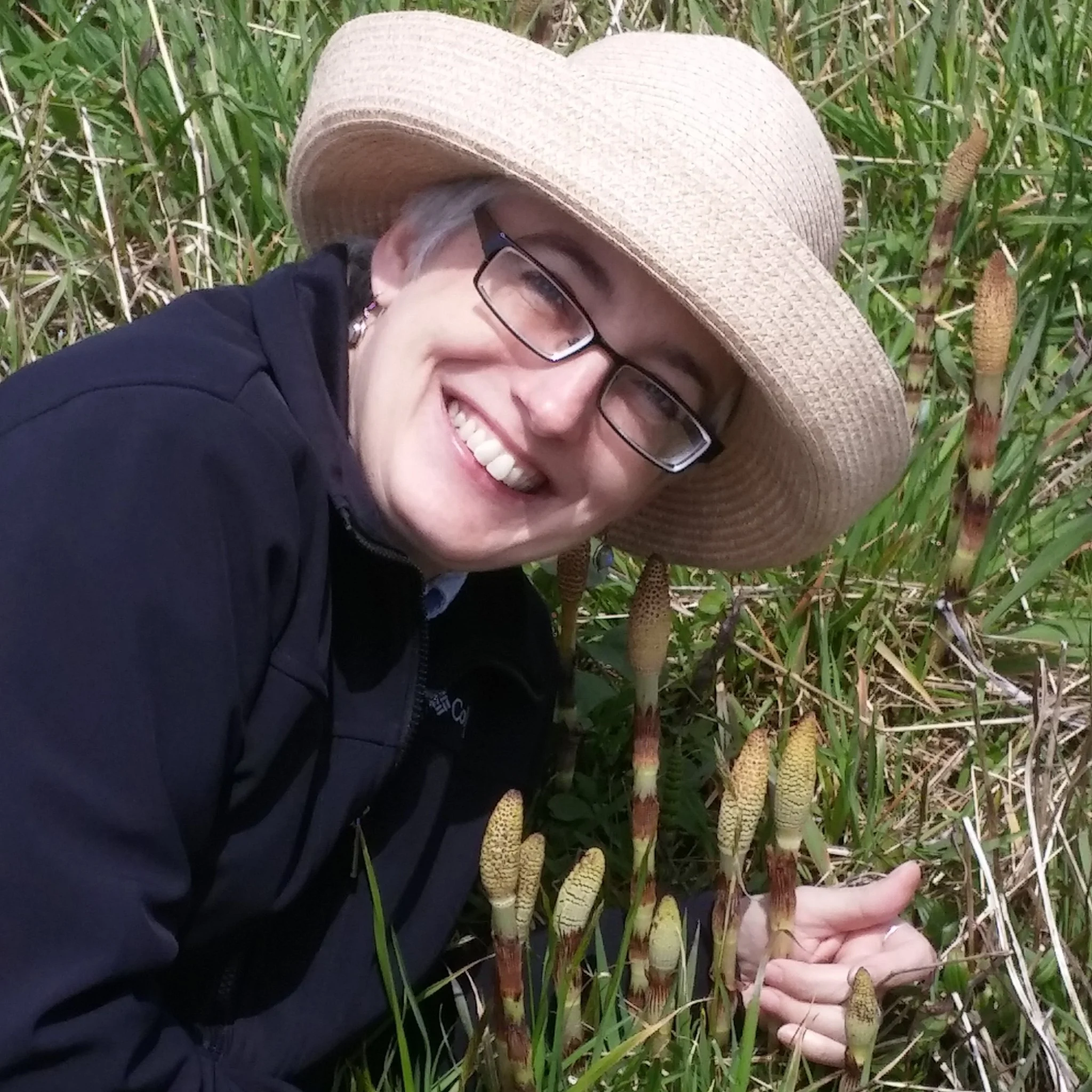 Dr. Melanie Link-Pérez, the 2018 ASPT Engagement and Excellence in Plant Systematics Education awardee, admires a healthy patch of Equisetum .