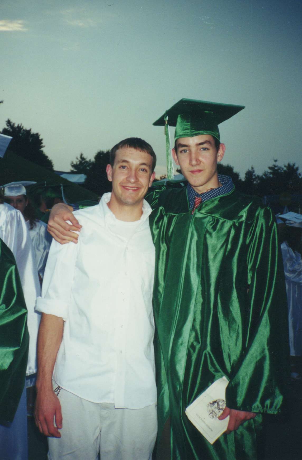 Kyle (right) standing with his brother at his high school graduation, 2000.