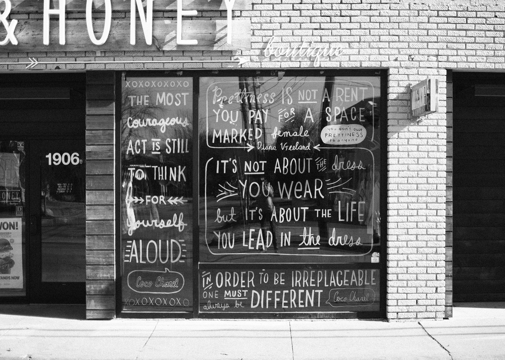 Kyle's hand-drawn words on the storefront of Milk & Honey boutique in Dallas.