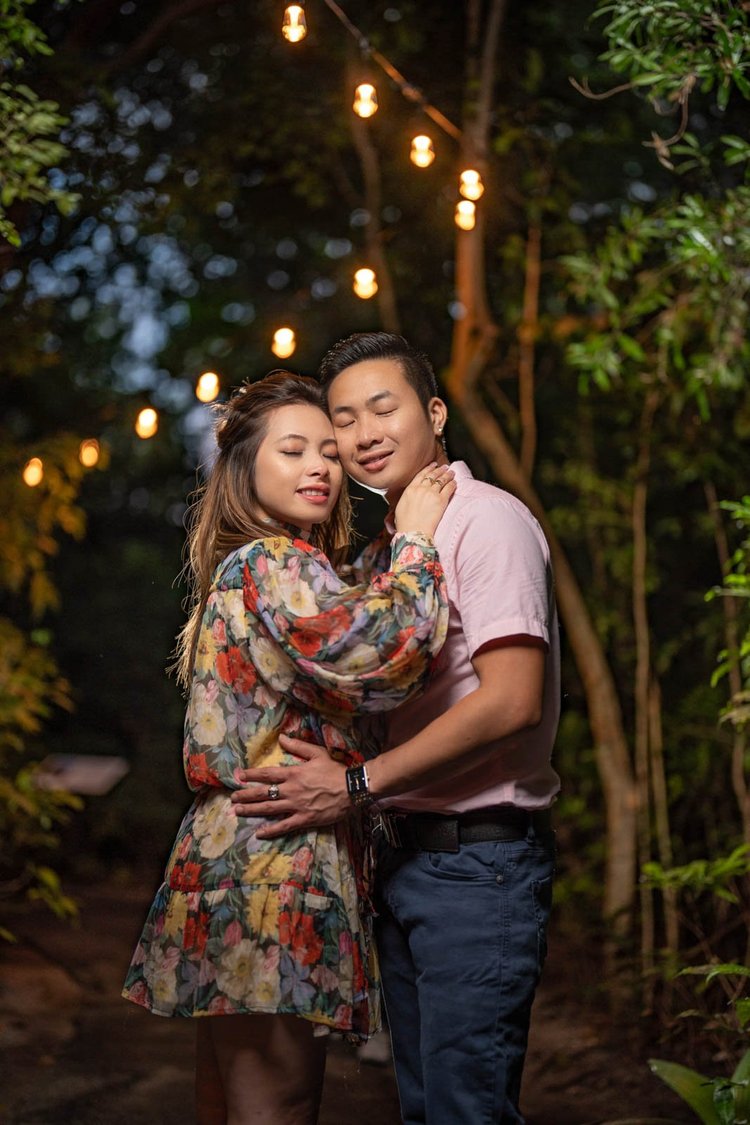 Engagement photos under string lights at night, by Henry M Production