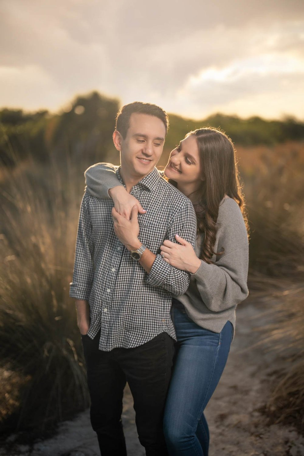 Couple laughing during a golden hour engagement session in Tampa Bay