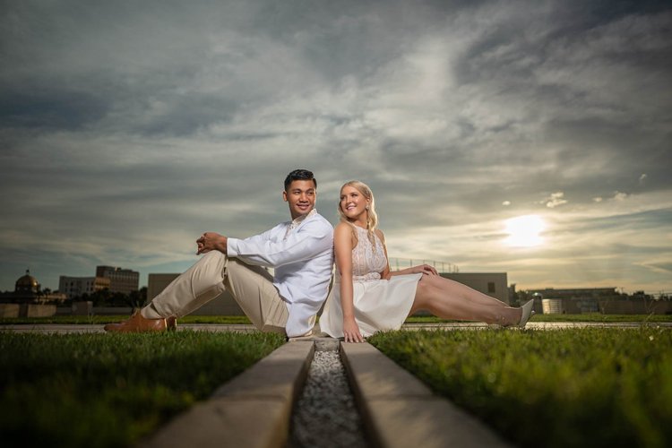 Engagement photos under a dramatic sunset sky, by Henry M Production