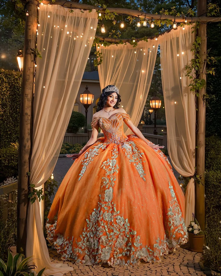 Quinceañera portrait in an orange gown under a draped canopy, by Henry M Production