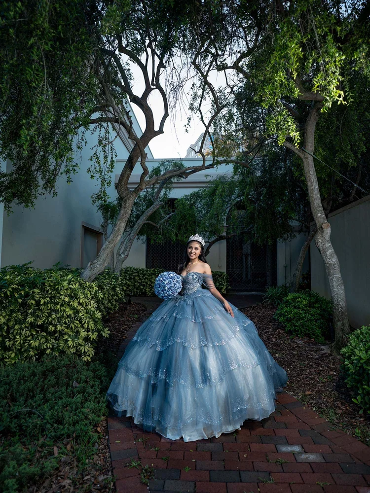 Quinceañera portrait in a lush courtyard garden, by Henry M Production