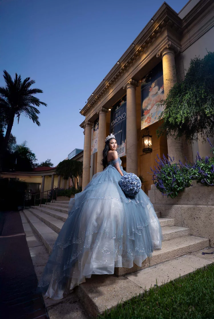 Quinceañera portrait on columned steps at dusk, by Henry M Production
