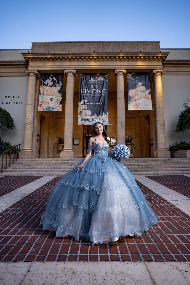 Quinceañera portrait on the steps of a historic museum, by Henry M Production