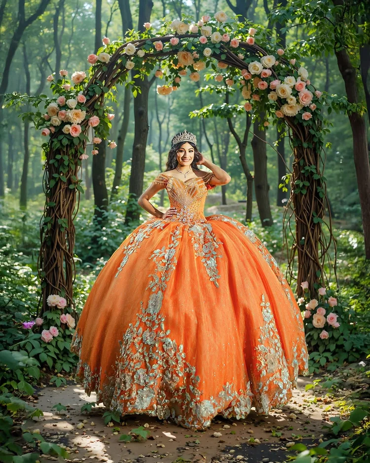 Quinceañera portrait in an orange gown beneath a floral arch, by Henry M Production