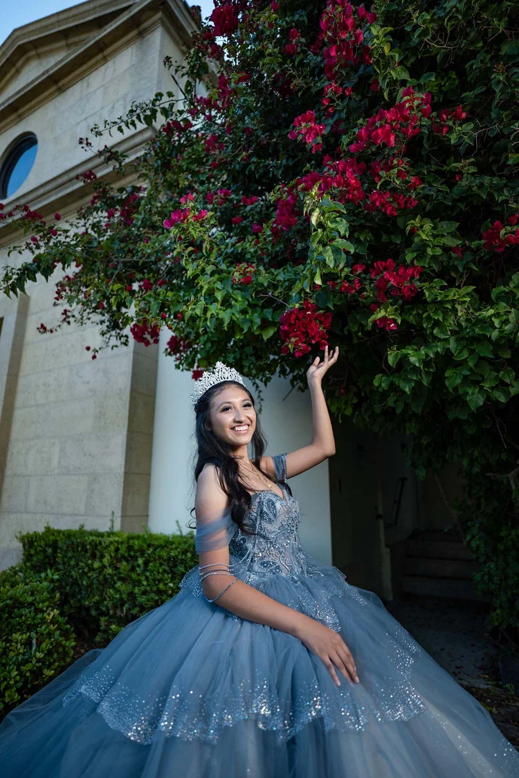 Quinceañera portrait beside red bougainvillea, by Henry M Production