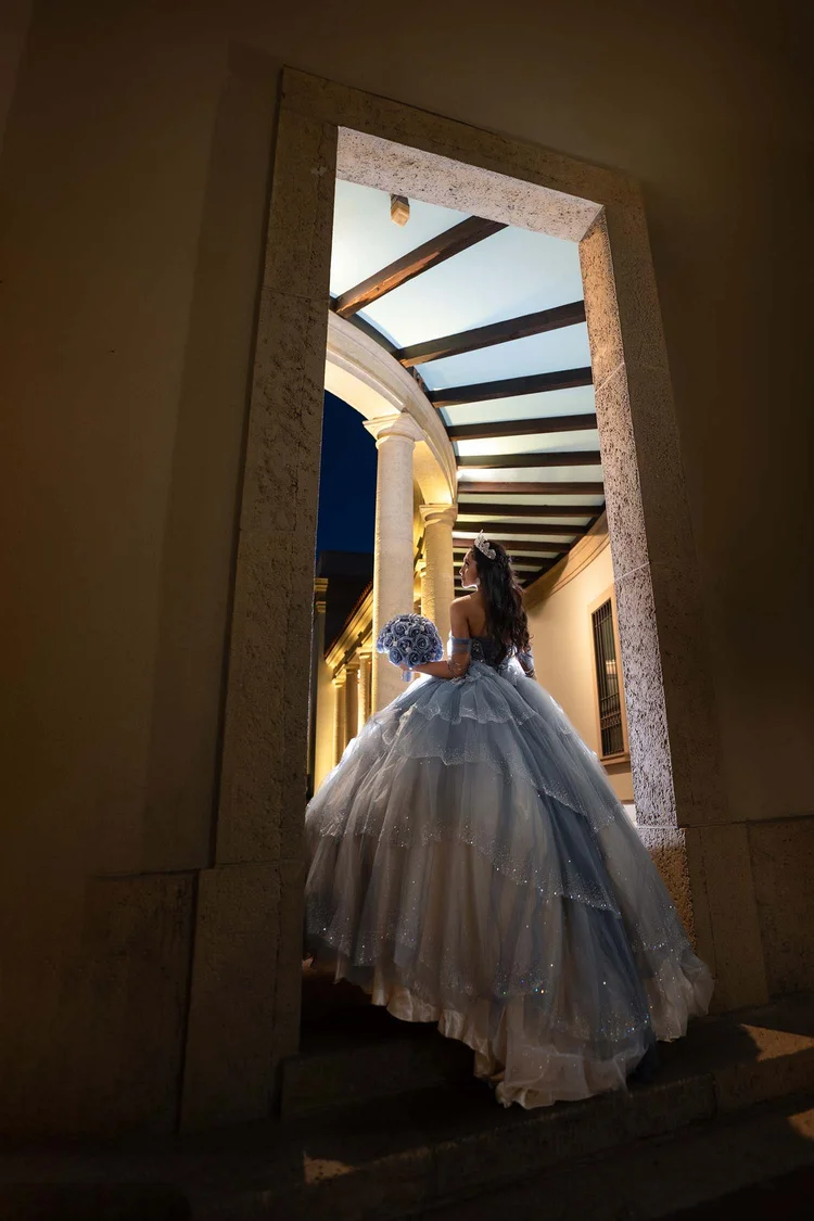 Quinceañera portrait in a lit doorway at night, by Henry M Production