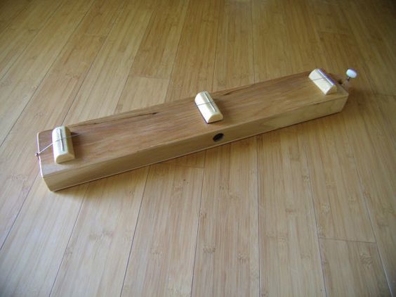 Children use the Monchord to strategically place fret-like pieces of wood underneath the string to match specific pitches heard.