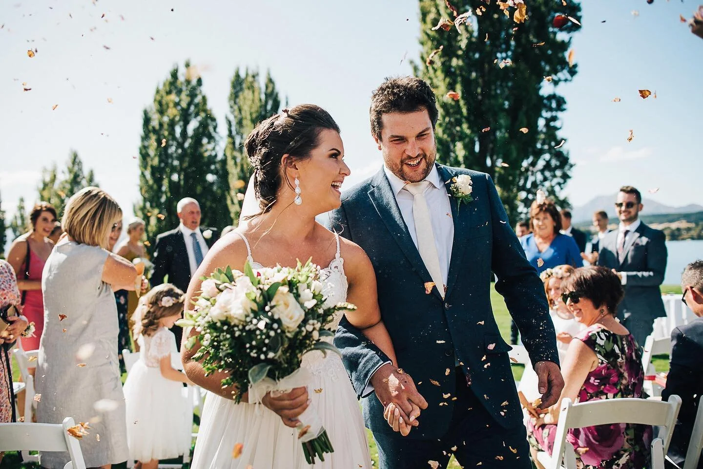 Jess &amp; Michael freshly married... well, before lockdown anyway! If you&rsquo;re thinking whether to do petals/confetti or not, just do it. Always looks awesome!
@weddings_at_edgewater 
@robertglen86 .
.
#nzwedding #nzbride #nzphotographer #wanaka #wanakaweddingphotographer #lakewanaka #nikon #newzealand #fearlessphotographer #lookslikefilm #socality #wanderfolk #visualscollective #visualsoflife #welltravelled #liveauthentic #makemoments #lifeofadventure #stayandwander #theoutbound  #thewandererscommunity #togetherjournal #simplyadventure #passionpassport #fortheloveofmountains #heyheyhellomay #madewithmastin #photobugcommunity #junebugweddings #andybrownphotography