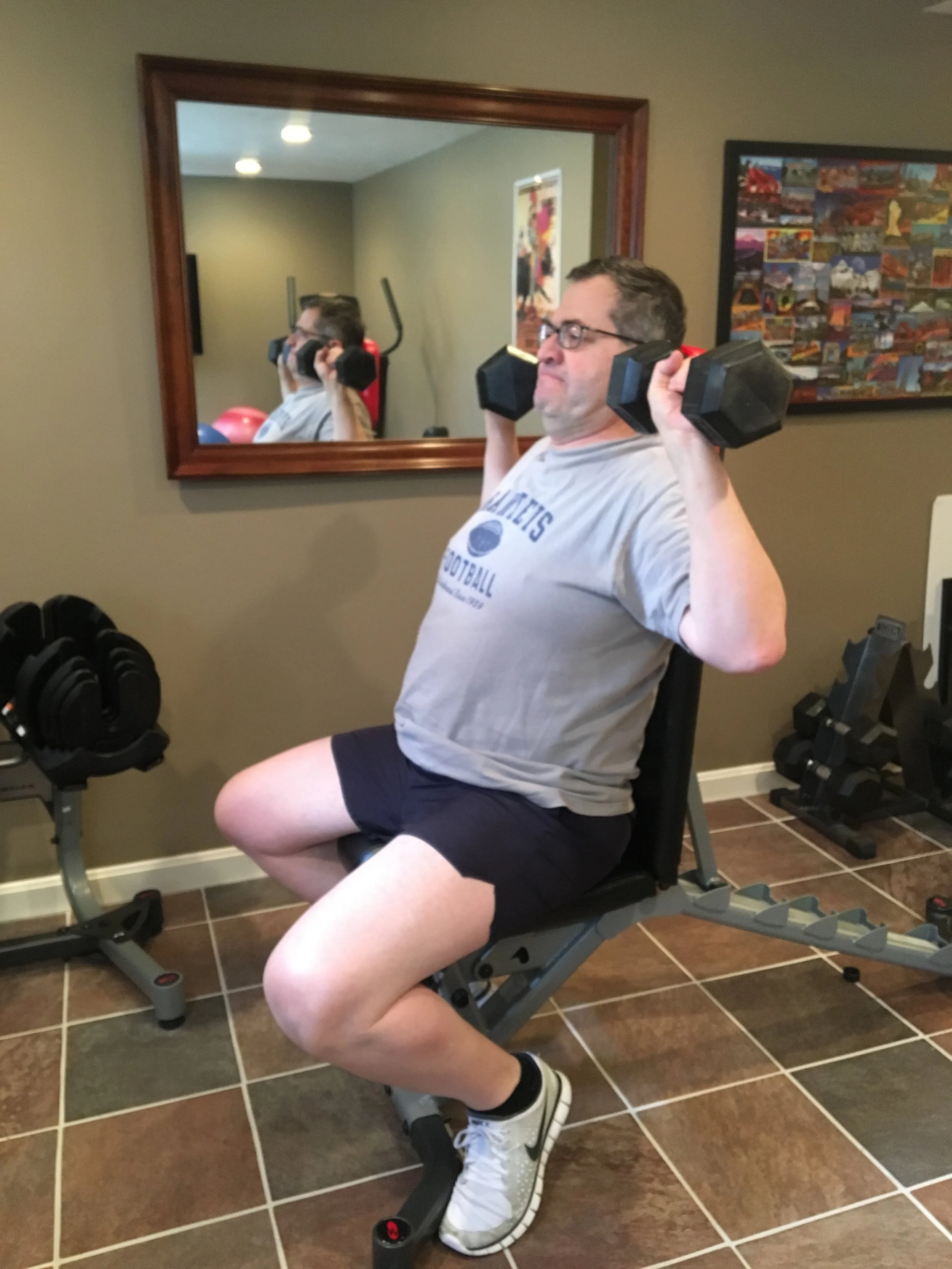  Working on shoulder strengthening with a seated military press. 