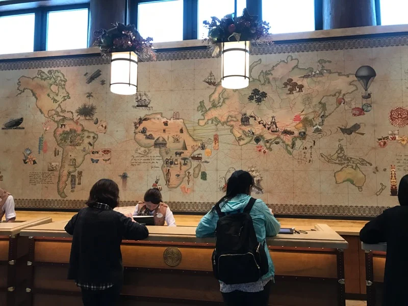 The check-in desk has a beautiful world map behind it!