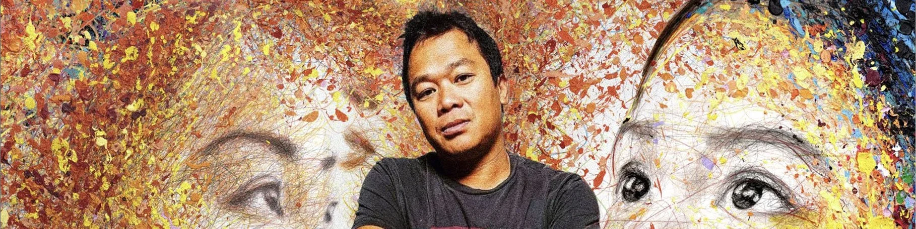 Hom Nguyen in front of one of his large-scale expressive portraits