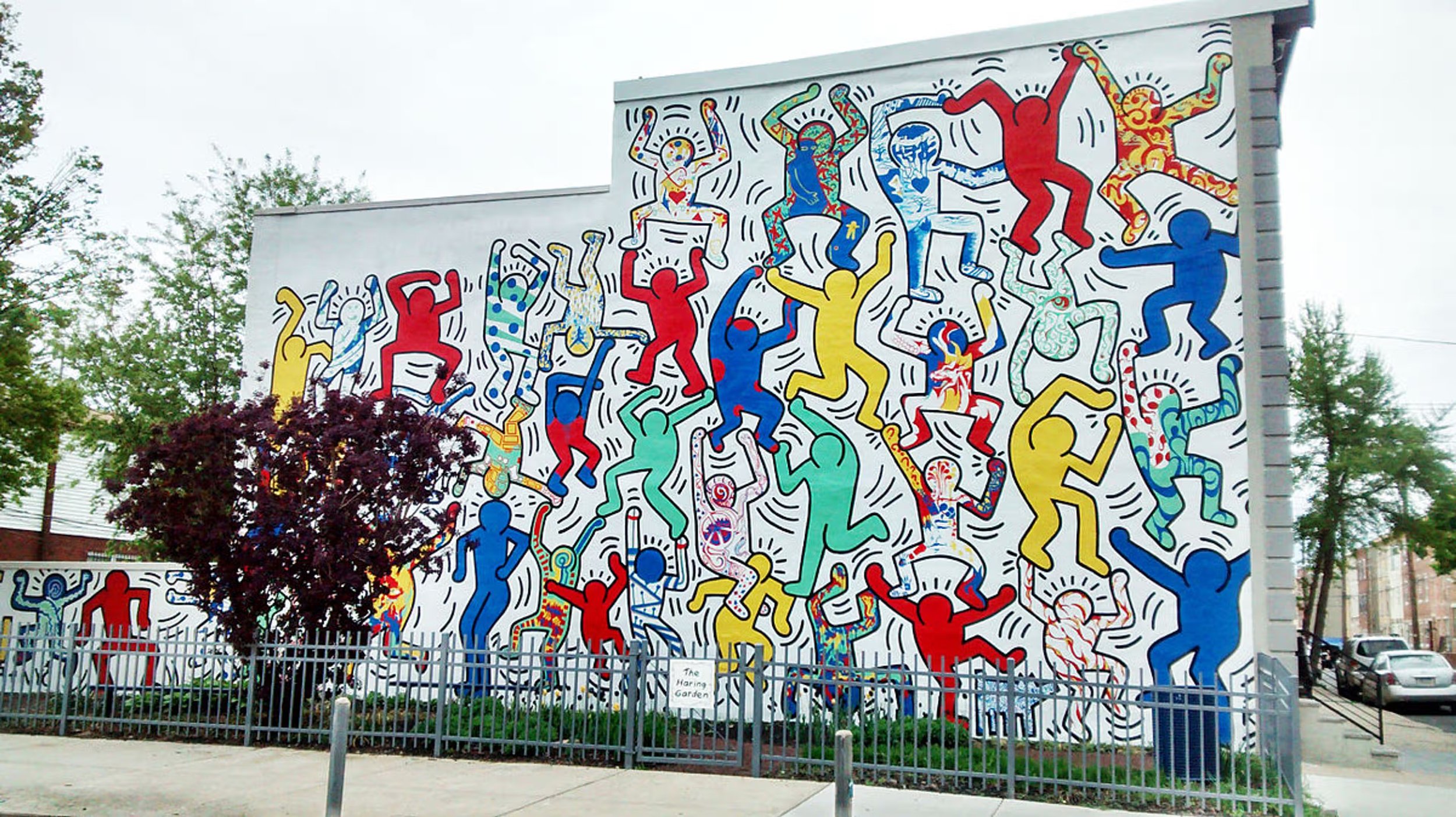 Colorful mural by Keith Haring featuring his signature dancing figures