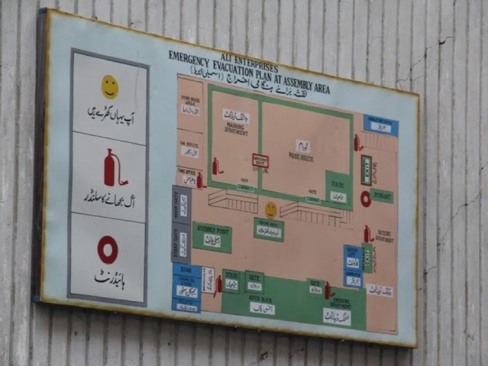 A sign board at the factory explaining the evacuation plan in case of emergency. PHOTO: AYESHA MIR/ THE EXPRESS TRIBUNE