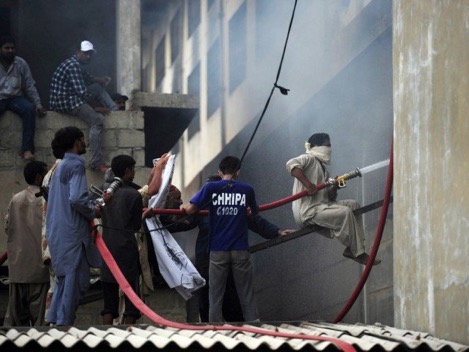 Firefighters battling the fire following day. PHOTO: AFP Note the lack of firefighting gear of the Fire Brigade staff.