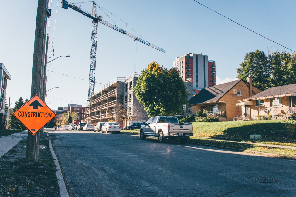 Figure 2: Combined enrollment increases at Waterloo’s two universities, from less than 25,000 in 2000 to approximately 40,000 in 2015 , have led to a boom in private student housing construction in the Northdale neighbourhood, located between the two institutions. Note the house to the right is for sale. Photo: Author