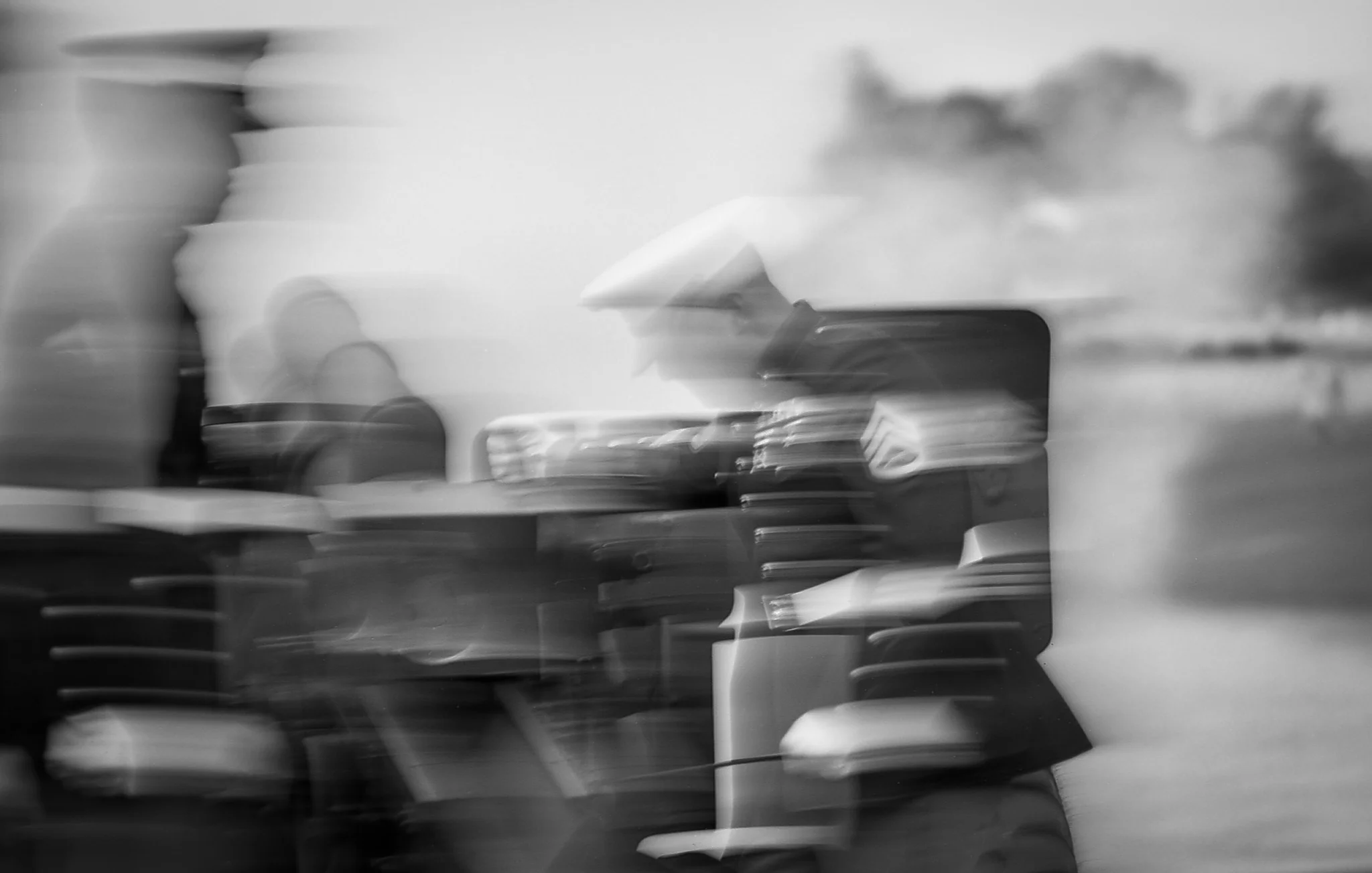 Slow shutter exposure of Marines loading and firing a Howitzer.
