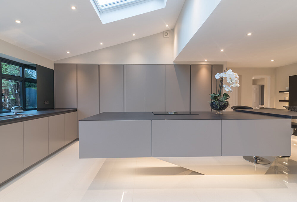 grey handleless kitchen with mirrored floating island