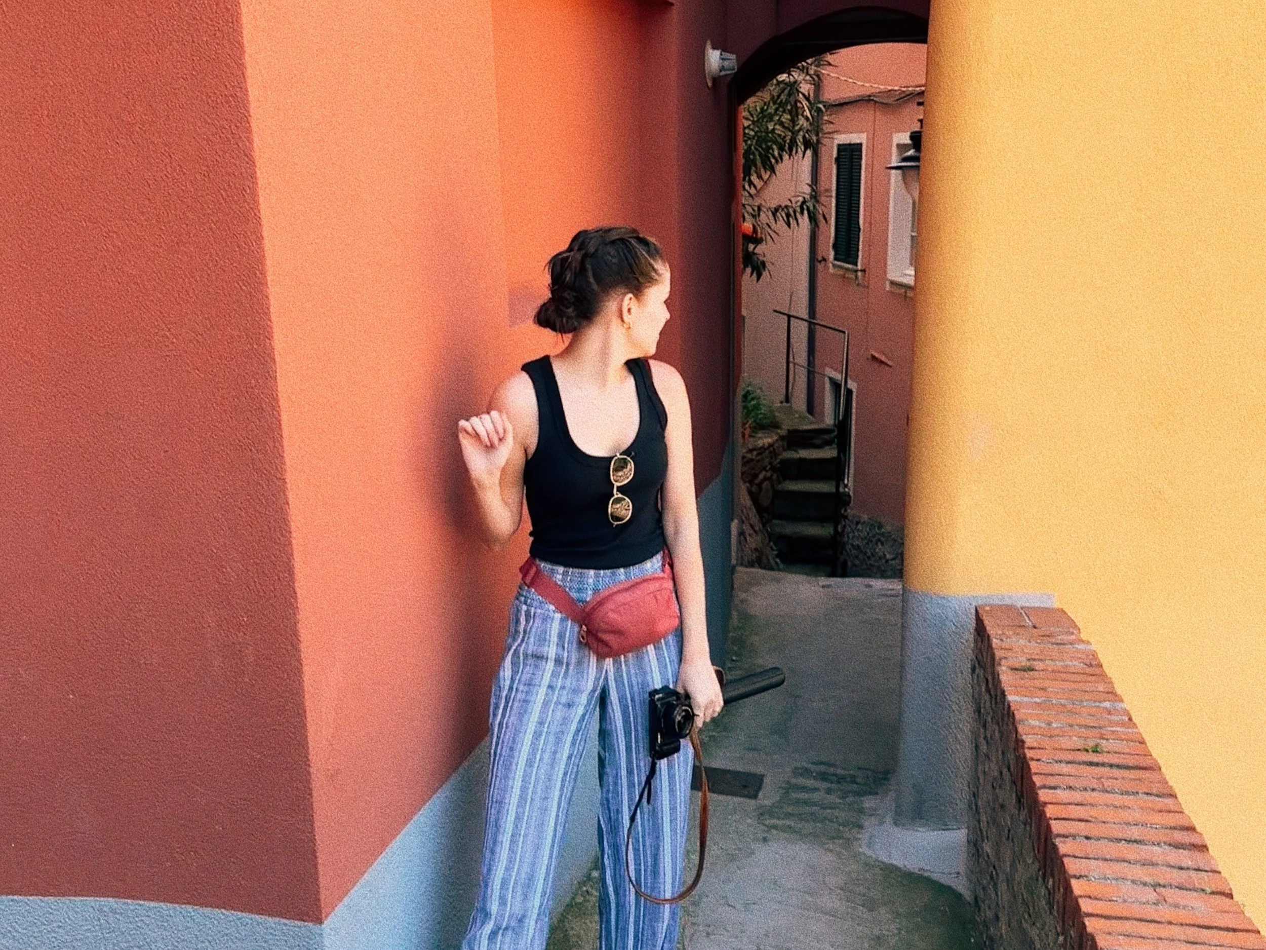 Megan in Italy posing near a colorful wall