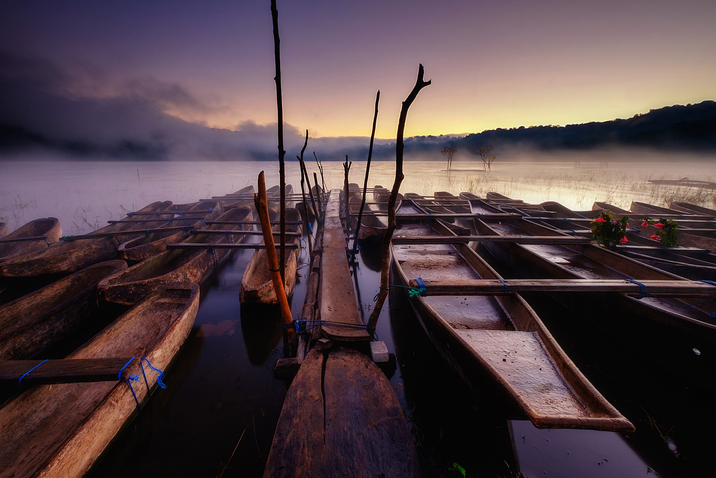 Tamblingan Dugout canoes at Tamblingan lake at dawn, Central Bali.