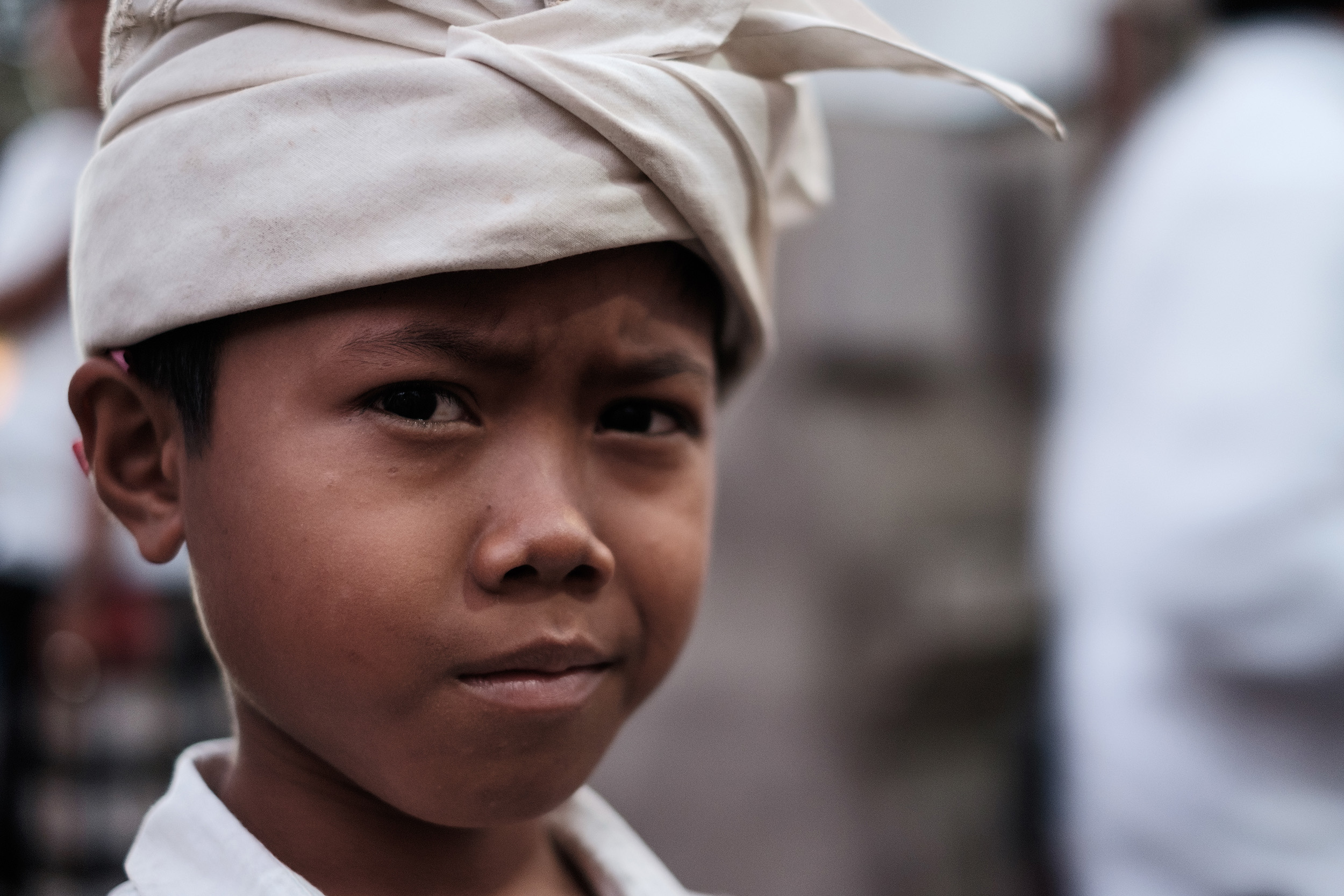 Ubud A balinese boy in traditional costume at a temple celebration in Ubud.