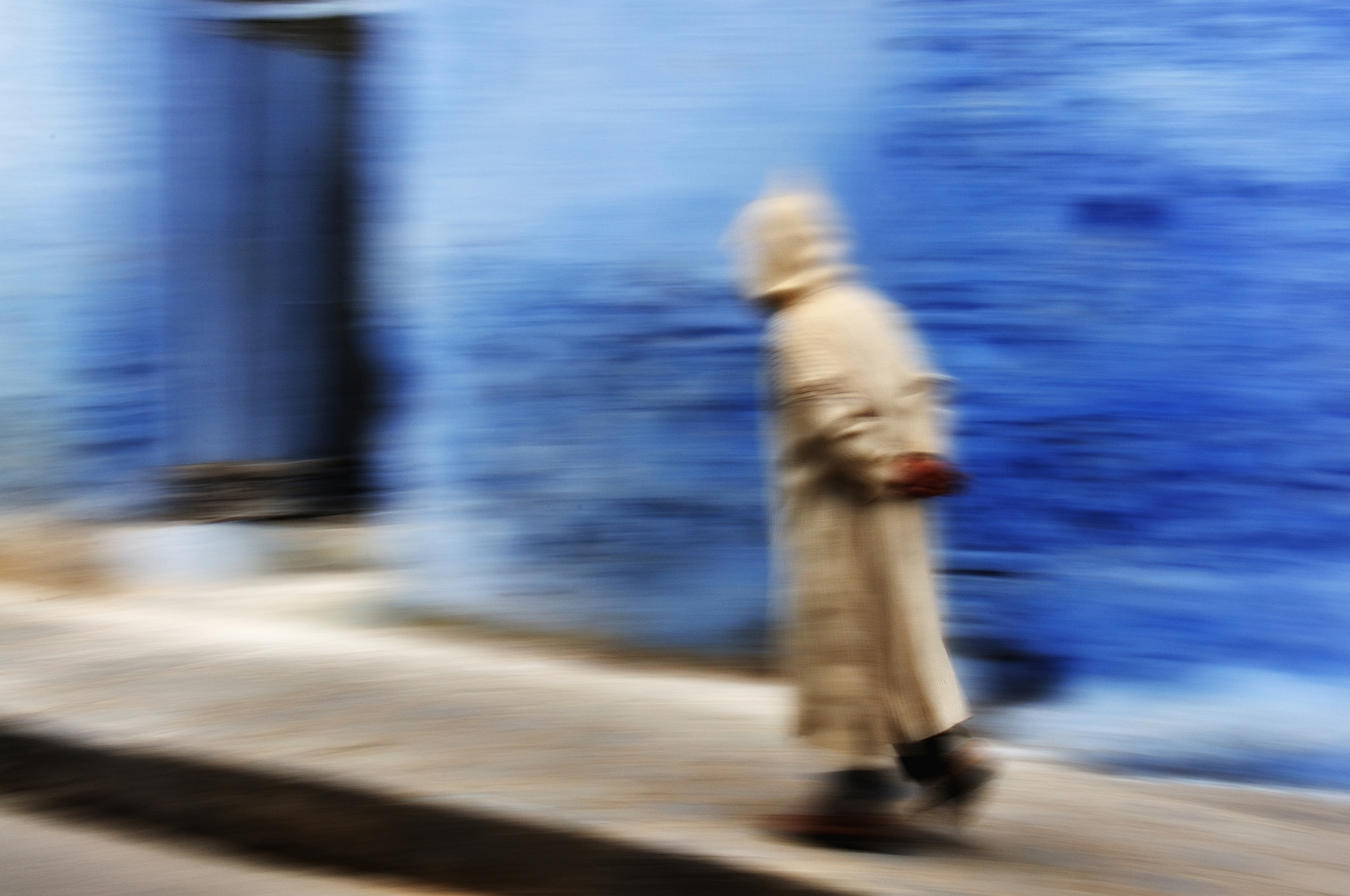 Chefchaouen A panning shot as a man walks through the blue town of Chefchaouen.