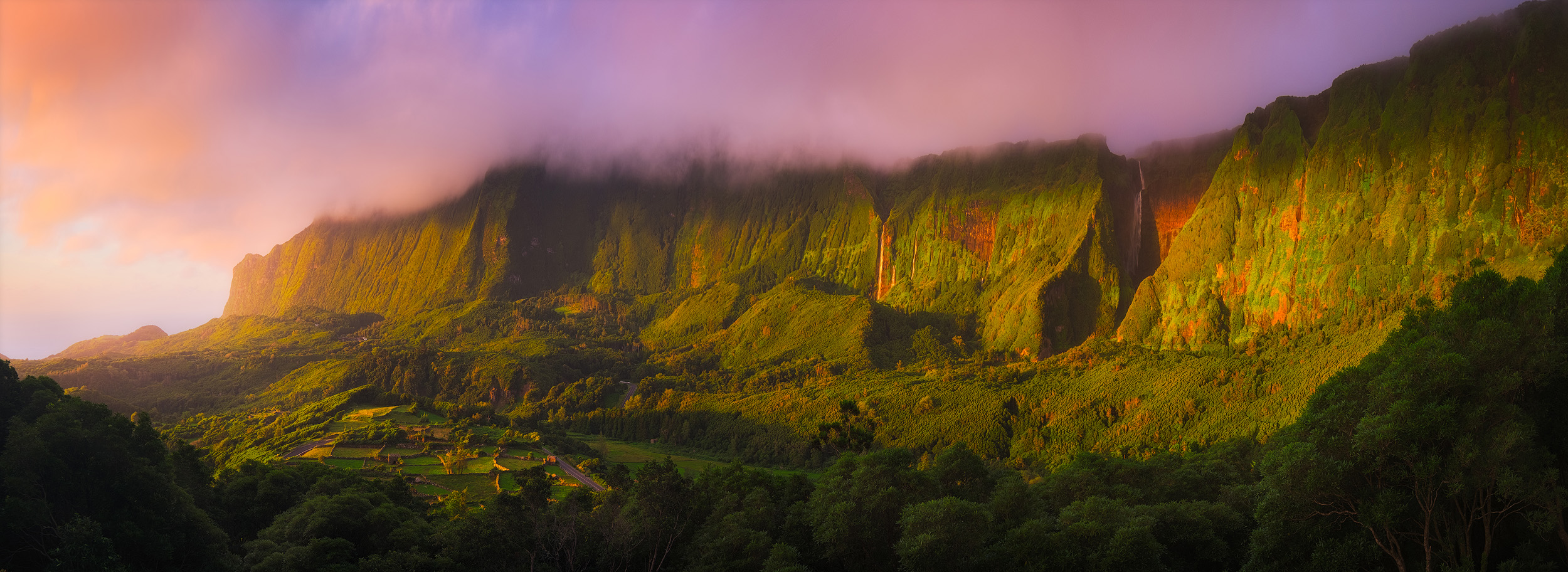 Flores Sunset Waterfalls tumble down the cliffs above Faja Grande on the west coast of Flores in the Azores at sunset