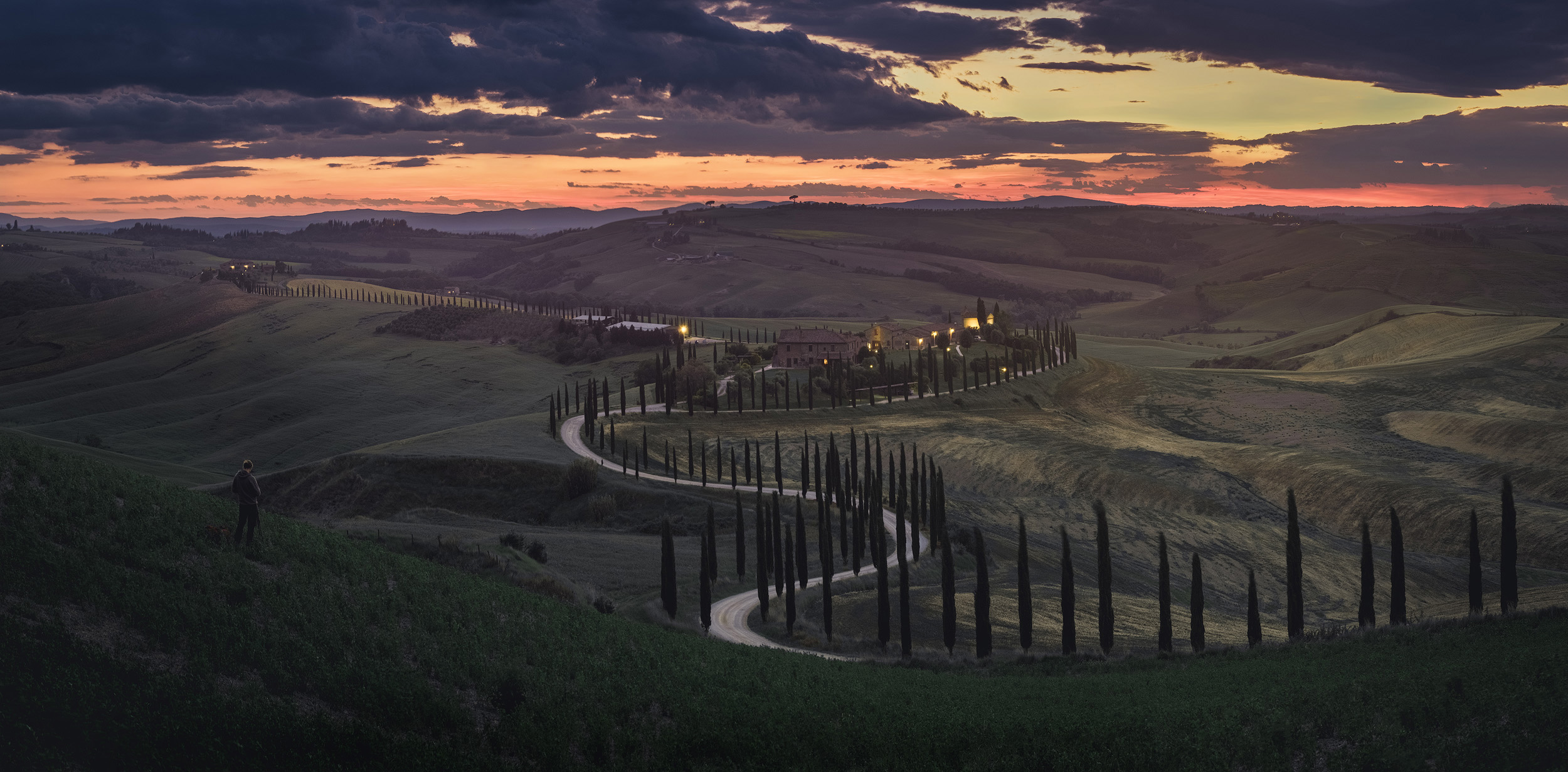 Crete Senesi Sunset in Crete Senesi. The barren hills and winding tree lined roads here have a very different feel to the more lush and familiar Val d'Orcia a little to the south