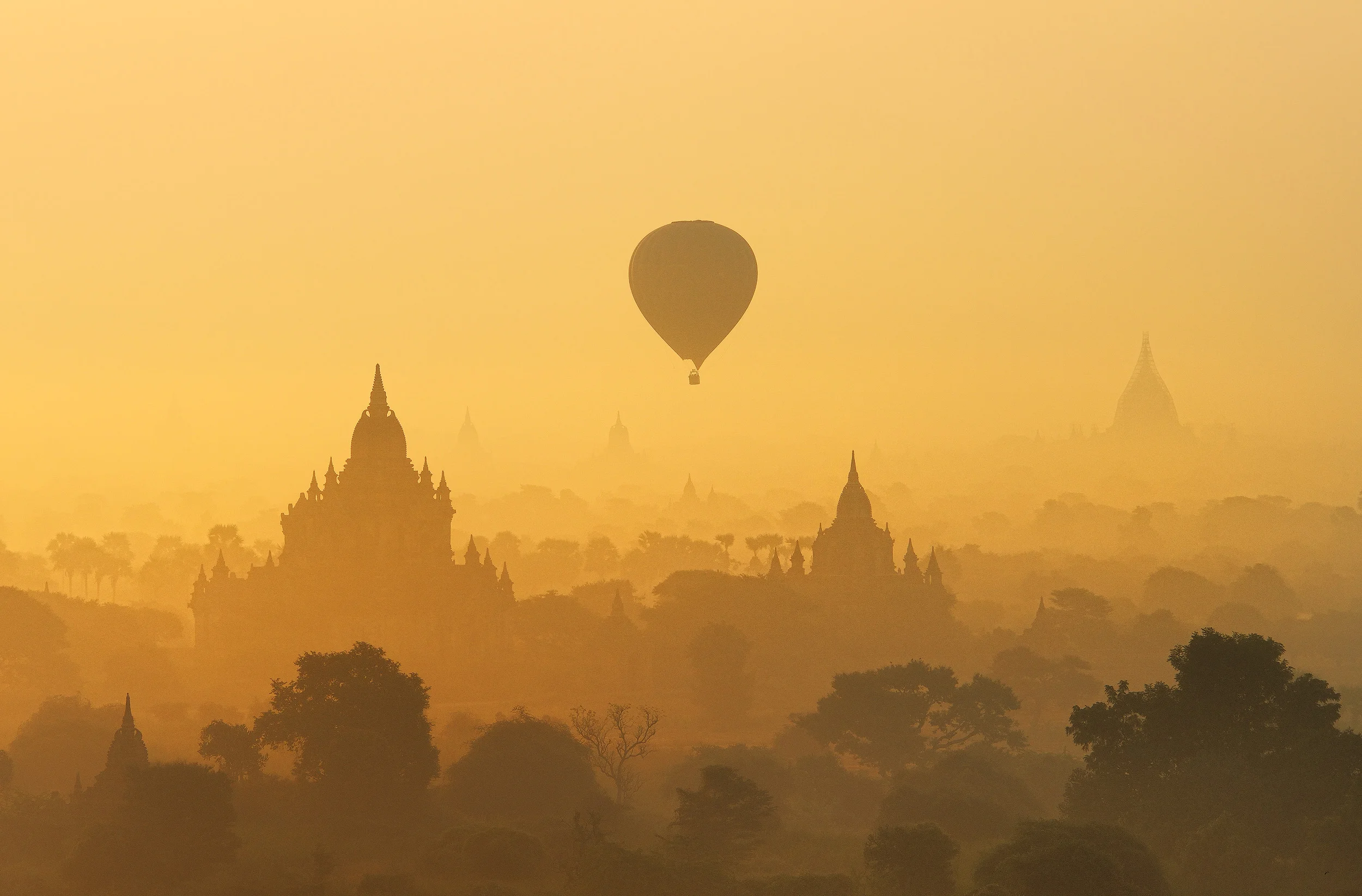 Bagan Sunrise Bagan is certainly one of the highlights of any trip to Burma, nothing could have prepared me for the majesty of the place on my first misty morning there. This has to be one of the most stunning places to see the sunrise on the planet. A vast plain covered with temples, it's certainly one the most amazing mornings I've ever had photographing the dawn. I shot for almost 3 hours at the top of a temple, from pre-dawn through the sunrise, and finally capturing warm light on the temples nearby.