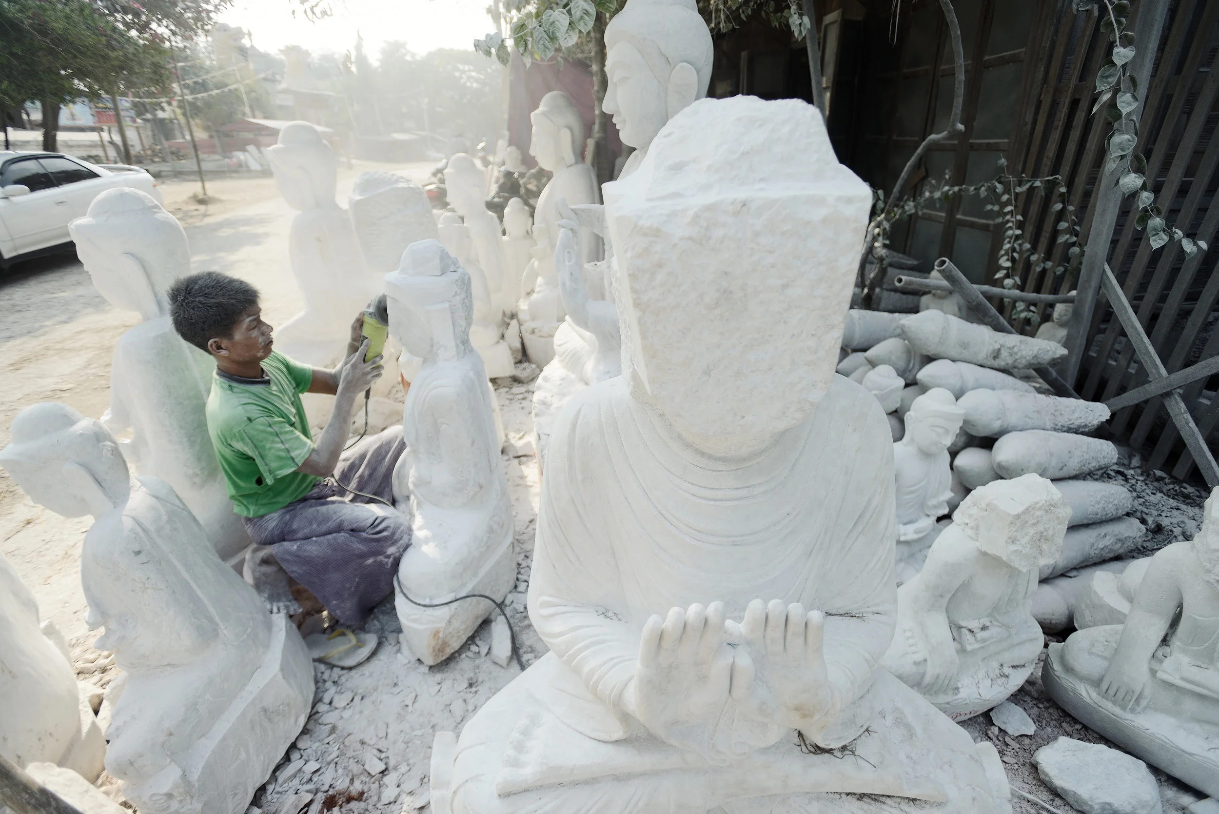 The Stone Carver II Another image of the stone carver shaping lumps of stone into Buddhas on the streets of Amarapur