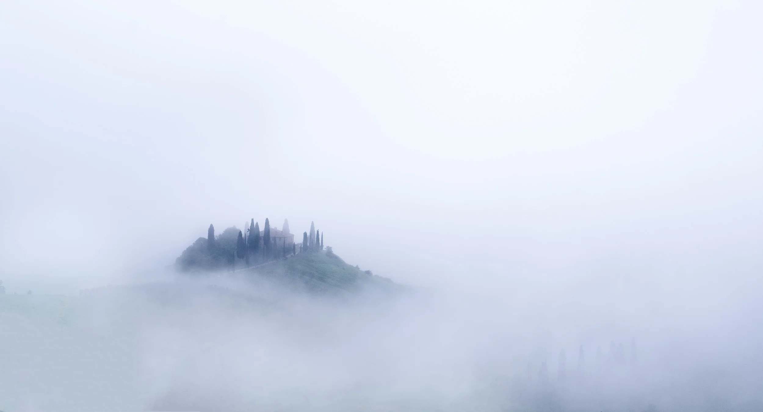 Dawn mist and fog swirls around Belvedere farmhouse