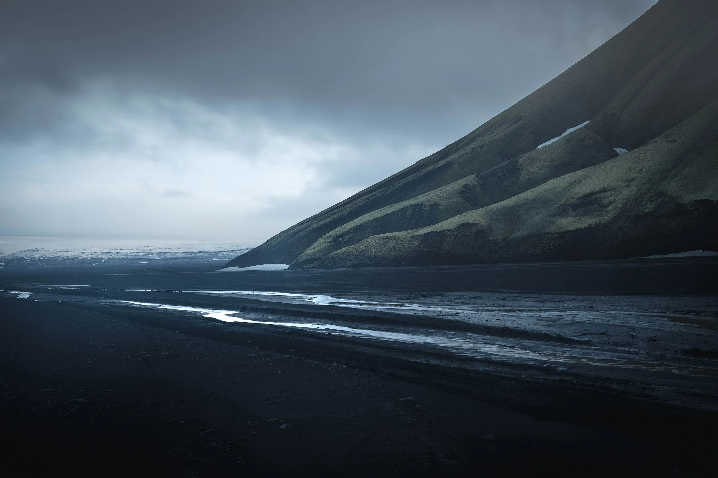 The foot of Maefell mountain on the Maefellsandur, the black sand desert at the foot of the Mýrdalsjökull glacier.