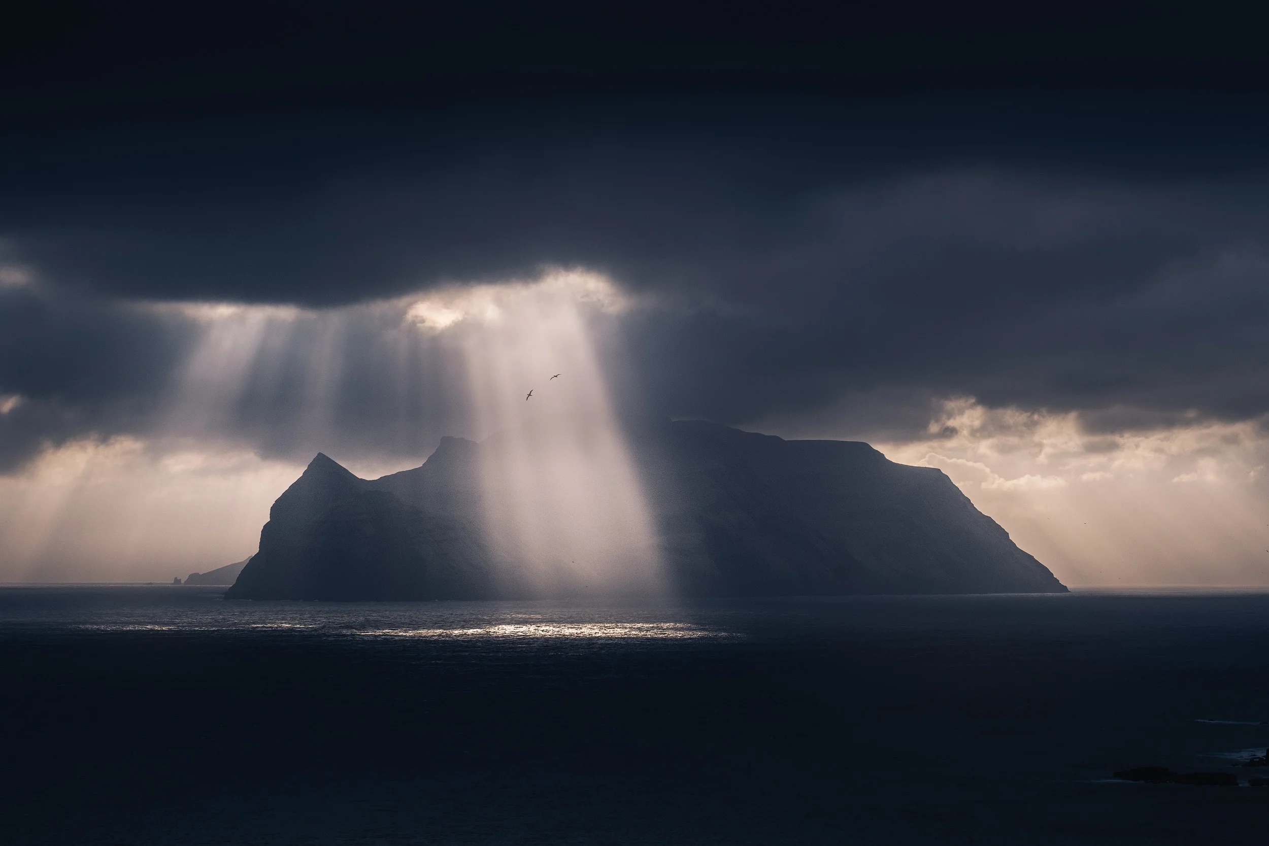 Bøur Dramatic light breaks over the island of Mykines, captured from the small village of Bøur in the island of Vagar