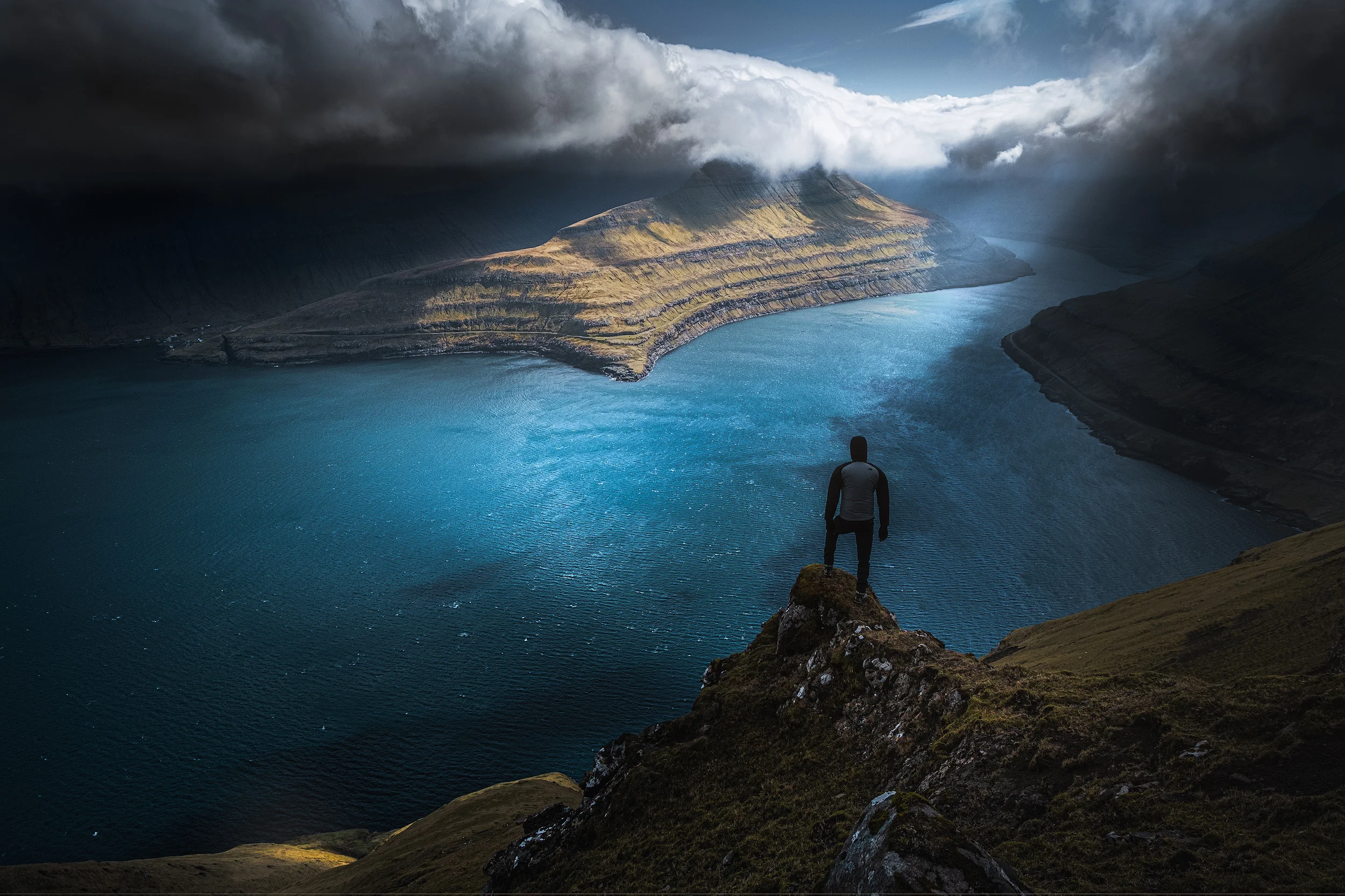 Hvithamar The ridge high above Funningsfjørður on the island of Streymoy in the Faroe Islands is one of the windiest places I’ve ever been. We could barely stand up from the wind, but the changing light from the heavy clouds made for a really dramatic scene and including my good friend and workshop co-leader Andrea Livieri into the frame gave an idea of the scale of the scene.