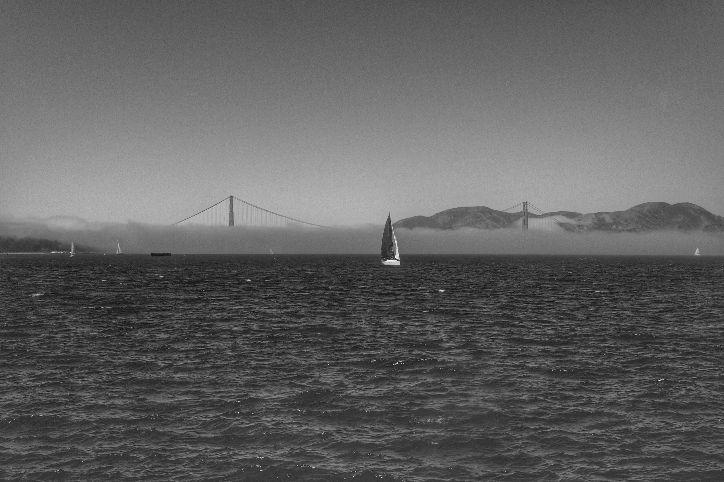 Fog and Sailboat. Golden Gate Bridge from Aquatic Park Pier. San Francisco. California. 2017.