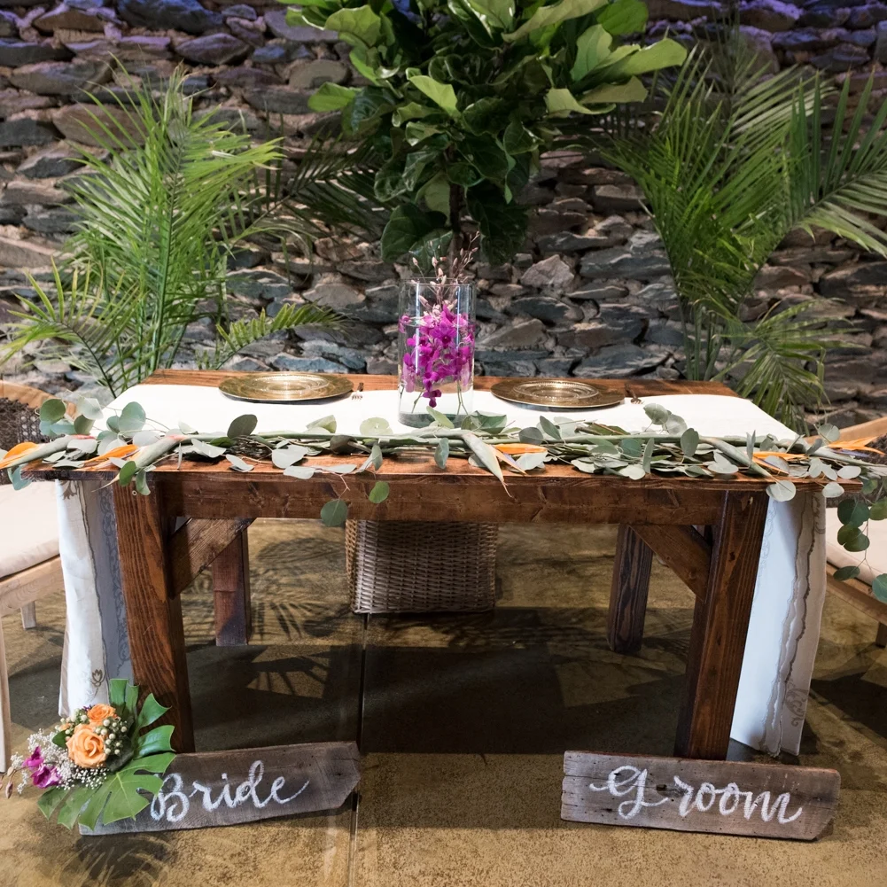 Wood bride and groom signs at sweetheart table