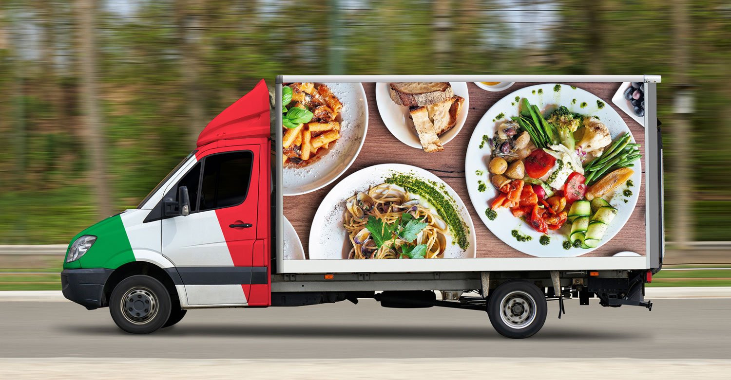 Italian food delivery truck in motion on road with trees in the background.jpg