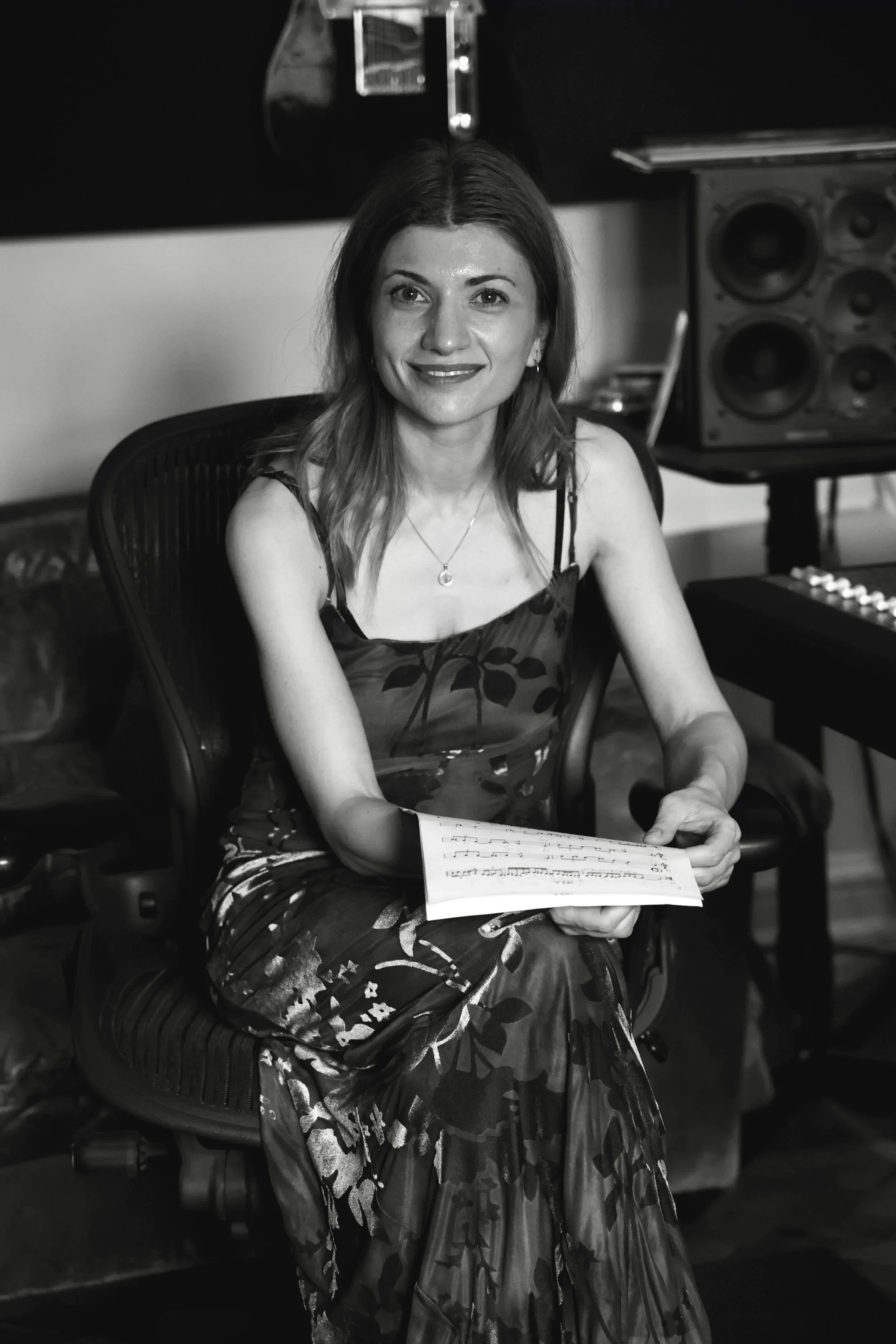 Knarika Karapetjana seated in the control room at Curtis Schwartz Studio, holding sheet music during a break in the recording session.